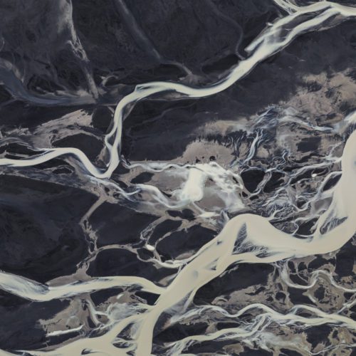 Glacial rivers in Iceland put up an incredible display when viewed from above. It's hard to imagine what it's like until you see one for yourself. This river reminds me of a big, but moving, piece of marble. It is just a small fragment of an enormous area where this glacial river braids itself through the land.