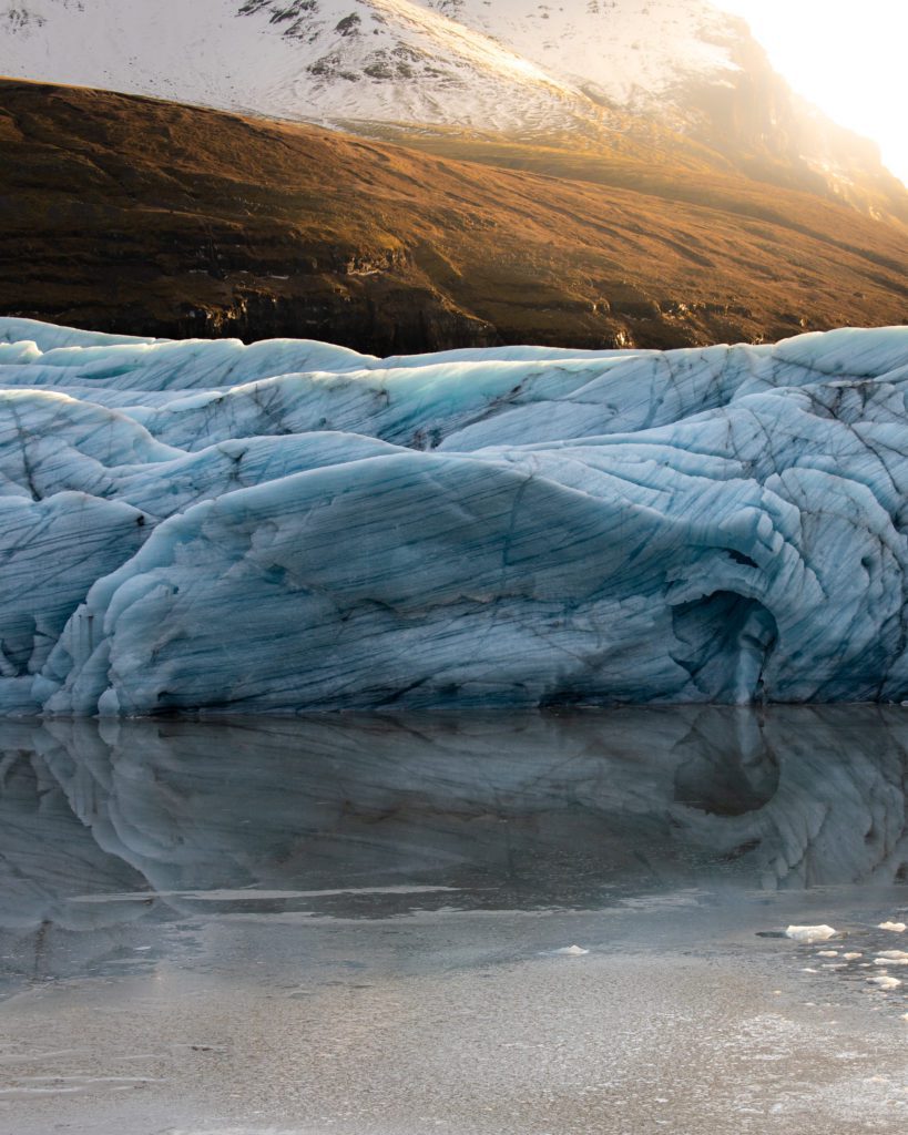 The Svínafellsjökull glacier reflecting in the ice surrounding it in South Iceland.