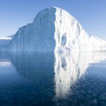 A contrasting symmetric photograph of an iceberg floating near Ilulissat, Greenland.