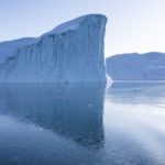 A reflection of a stunning iceberg in Ilulissat, Greenland.