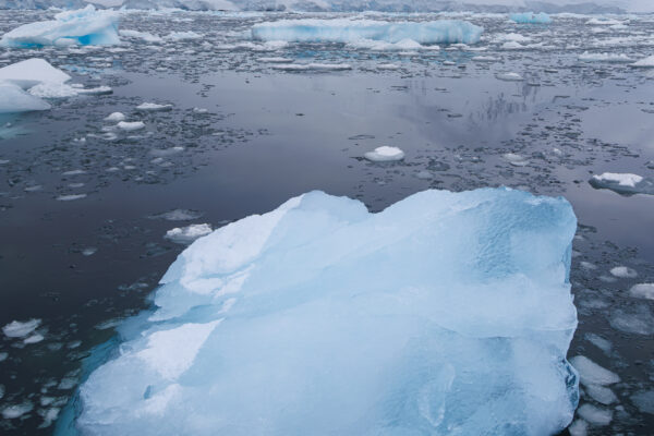 Crystal blue ice floating in a dramatic landscape