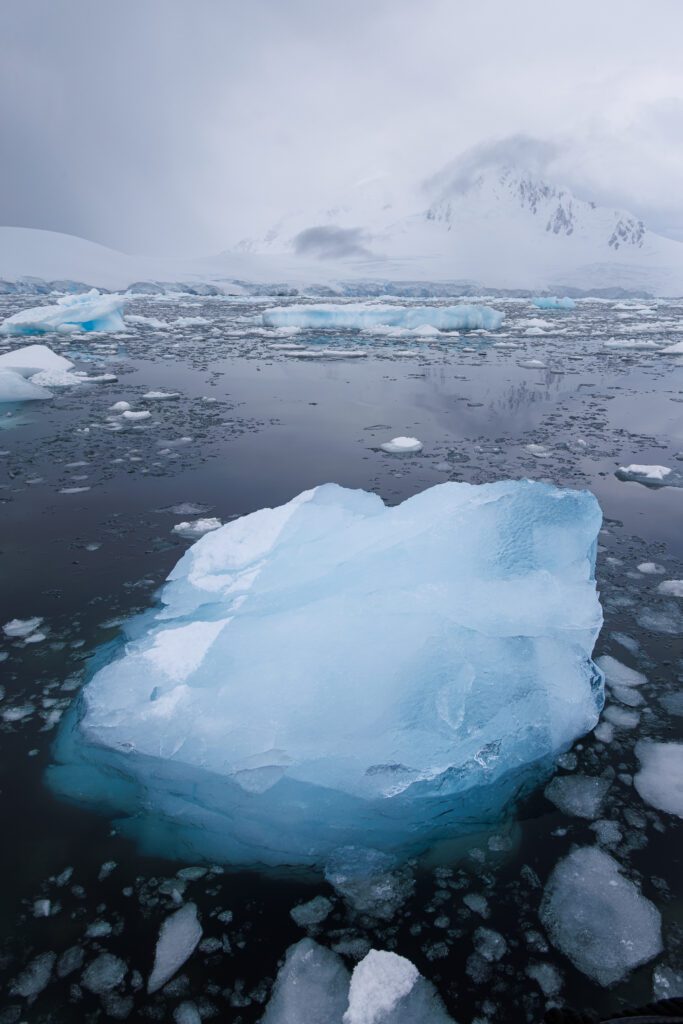 Crystal blue ice floating in a dramatic landscape