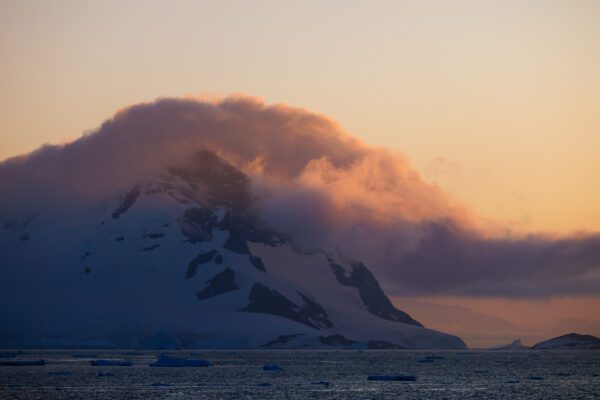 Dramatic sunset over a cloud covered mountain