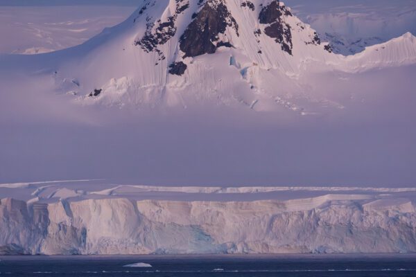 A sharp snow-covered mountain in a beautiful twilight colour.