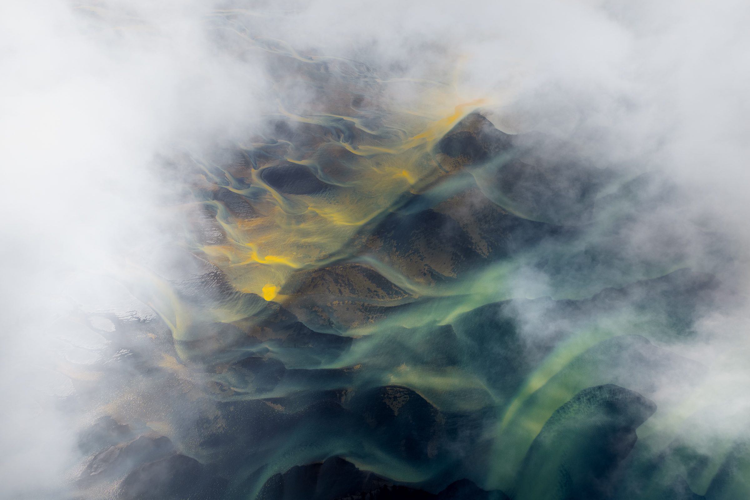 Braided rivers in Iceland engulfed by low clouds