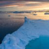 Iceberg edge at sunrise above the ice-filled waters of Disko Bay, Greenland.