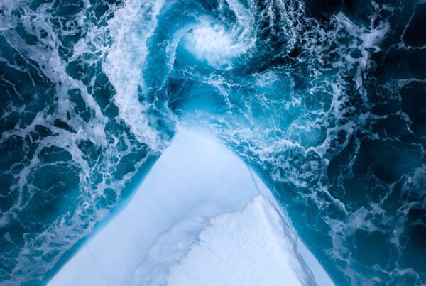 A whirlpool next to an iceberg in Greenland