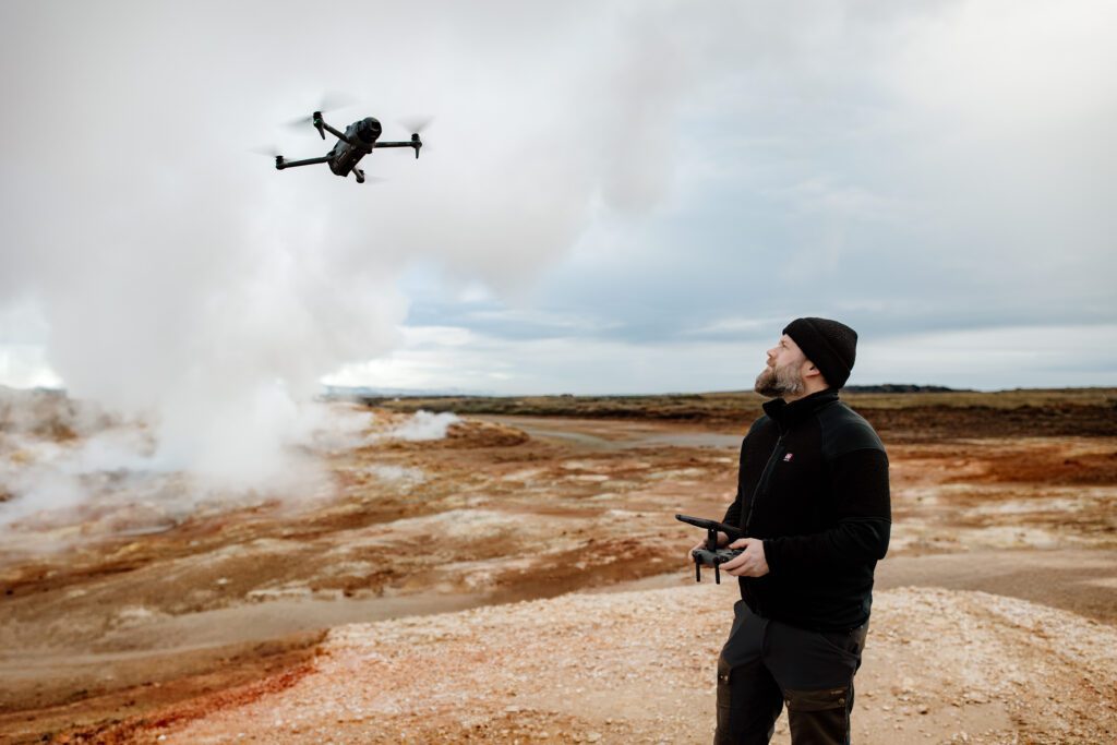 Profile portrait of Jeroen Van Nieuwenhove holding a Mavic 4 Pro controller in an Icelandic wool sweater.