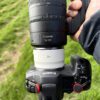 Top-down view of the RF 70-200mm F2.8 Z with the RF 2x extender on a Canon EOS R5, held over grass